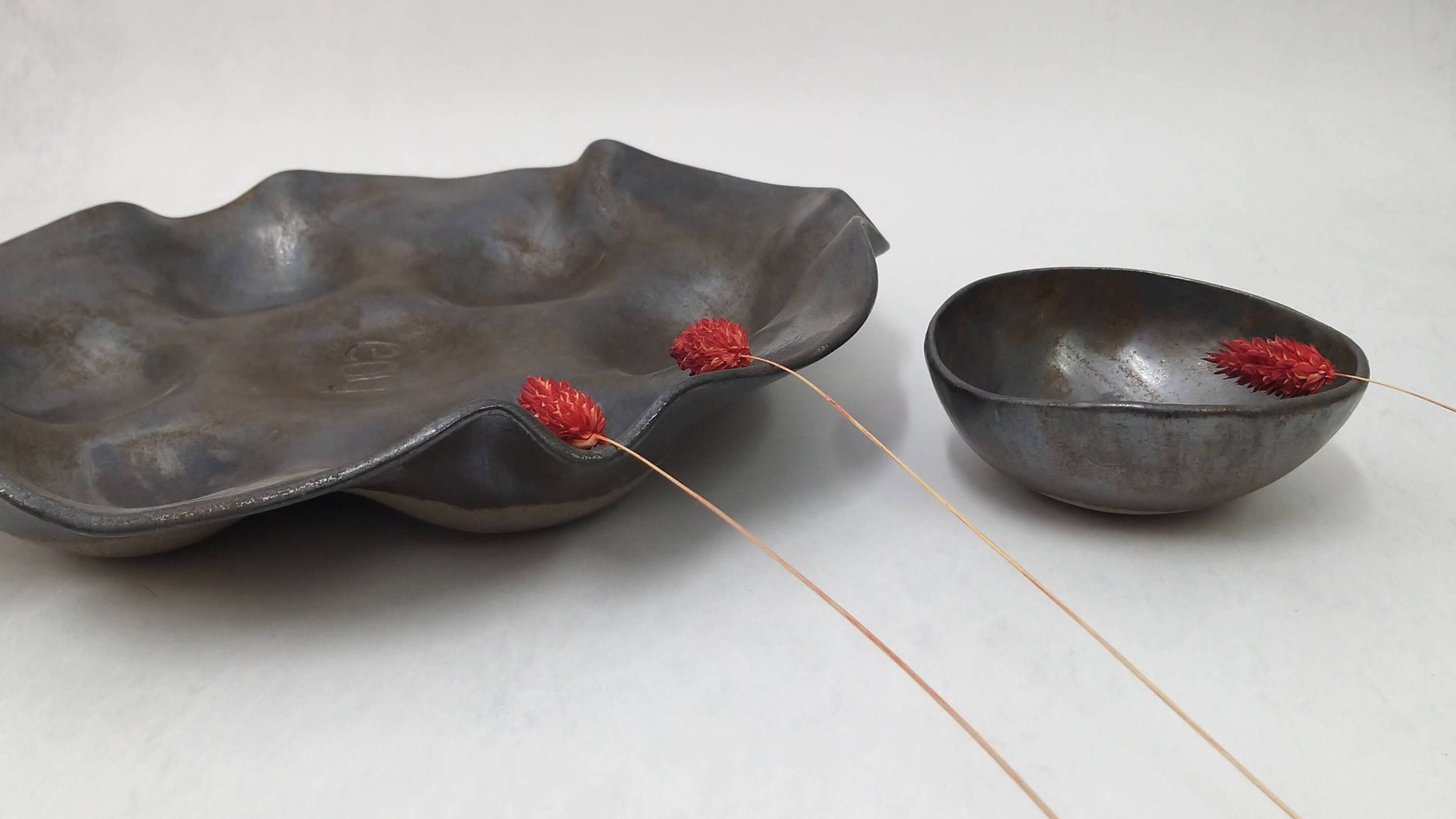 Wavy ceramic serving platter with matching bowl