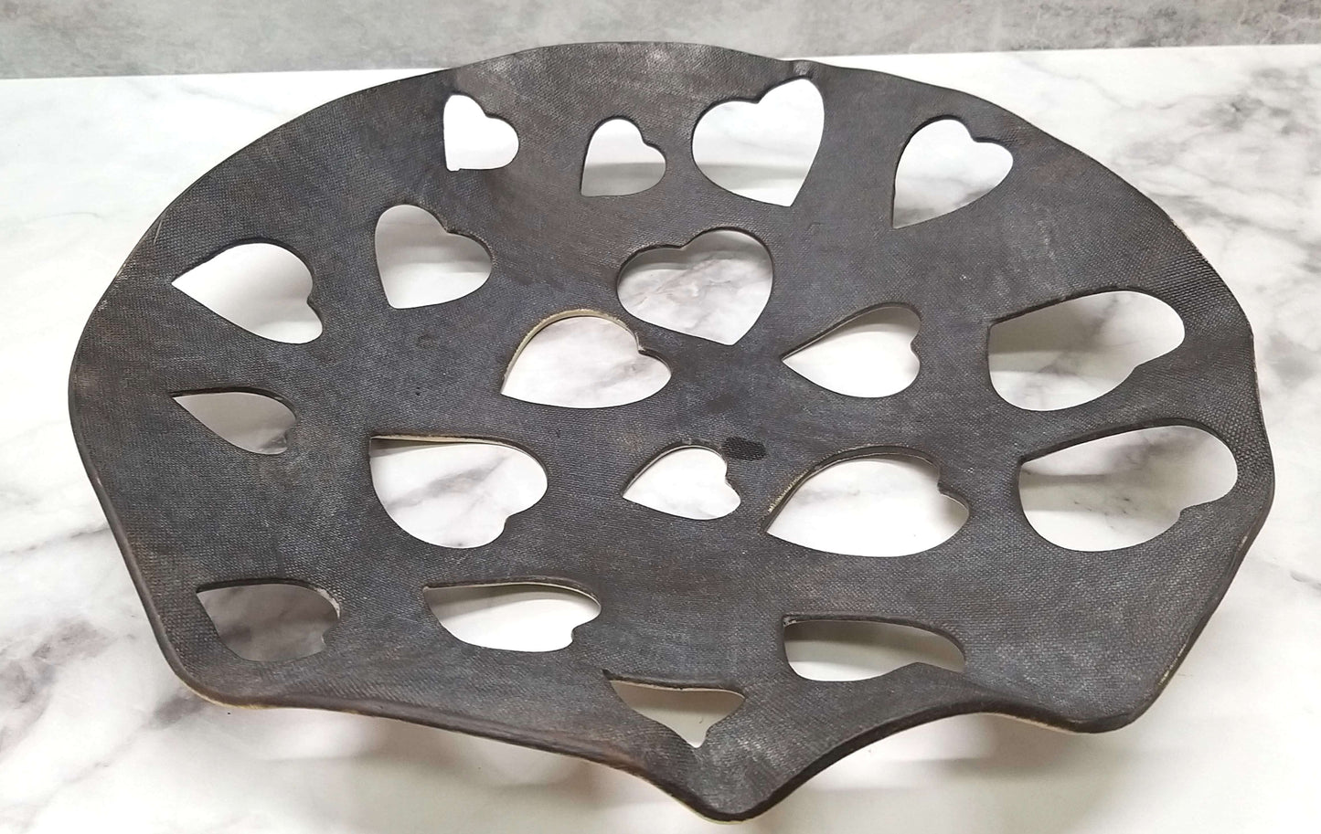 Metallic black ceramic bowl with widely spaced 3cm heart-shaped cutouts