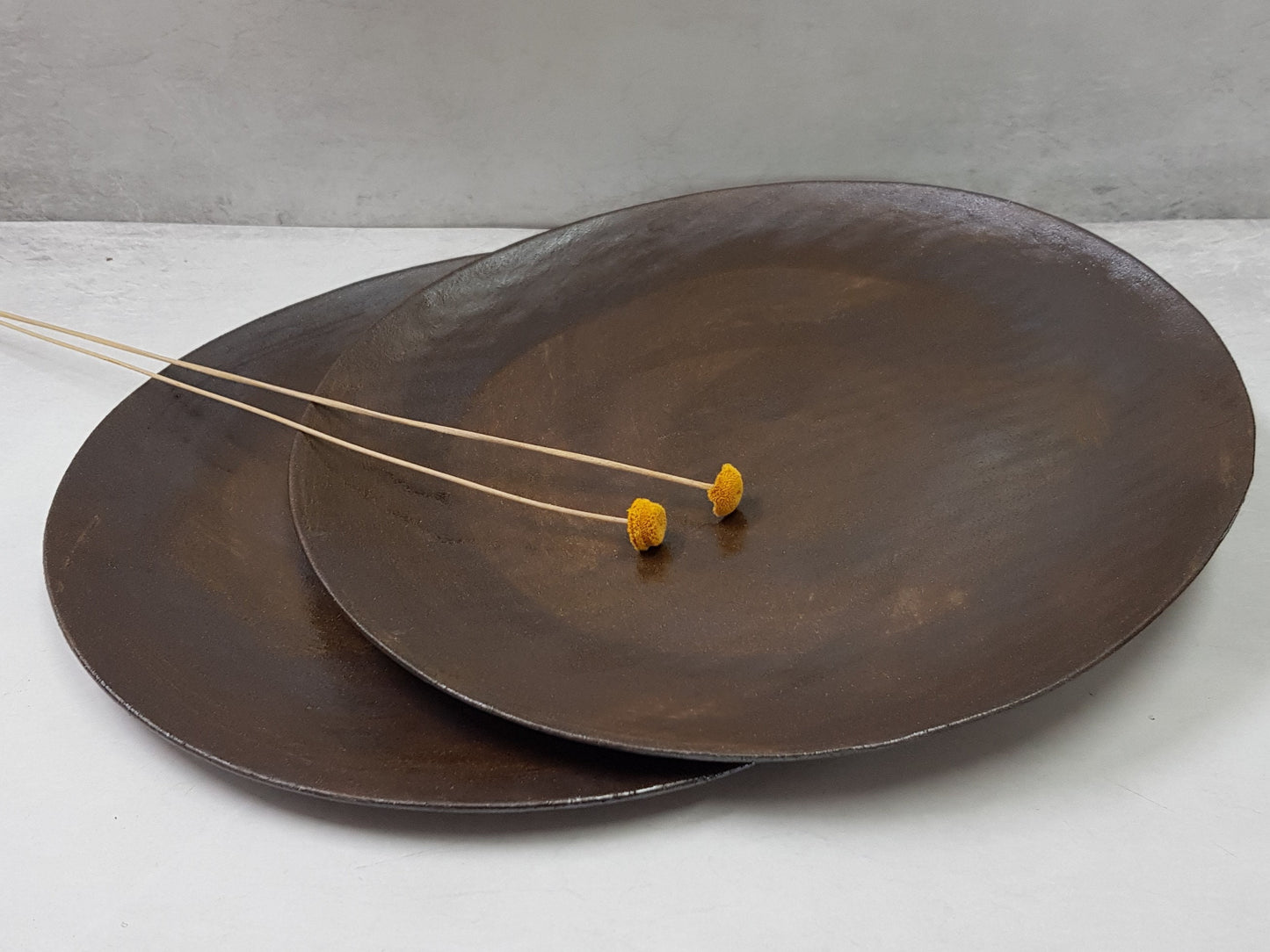 Handmade ceramic plate in brown-black glaze