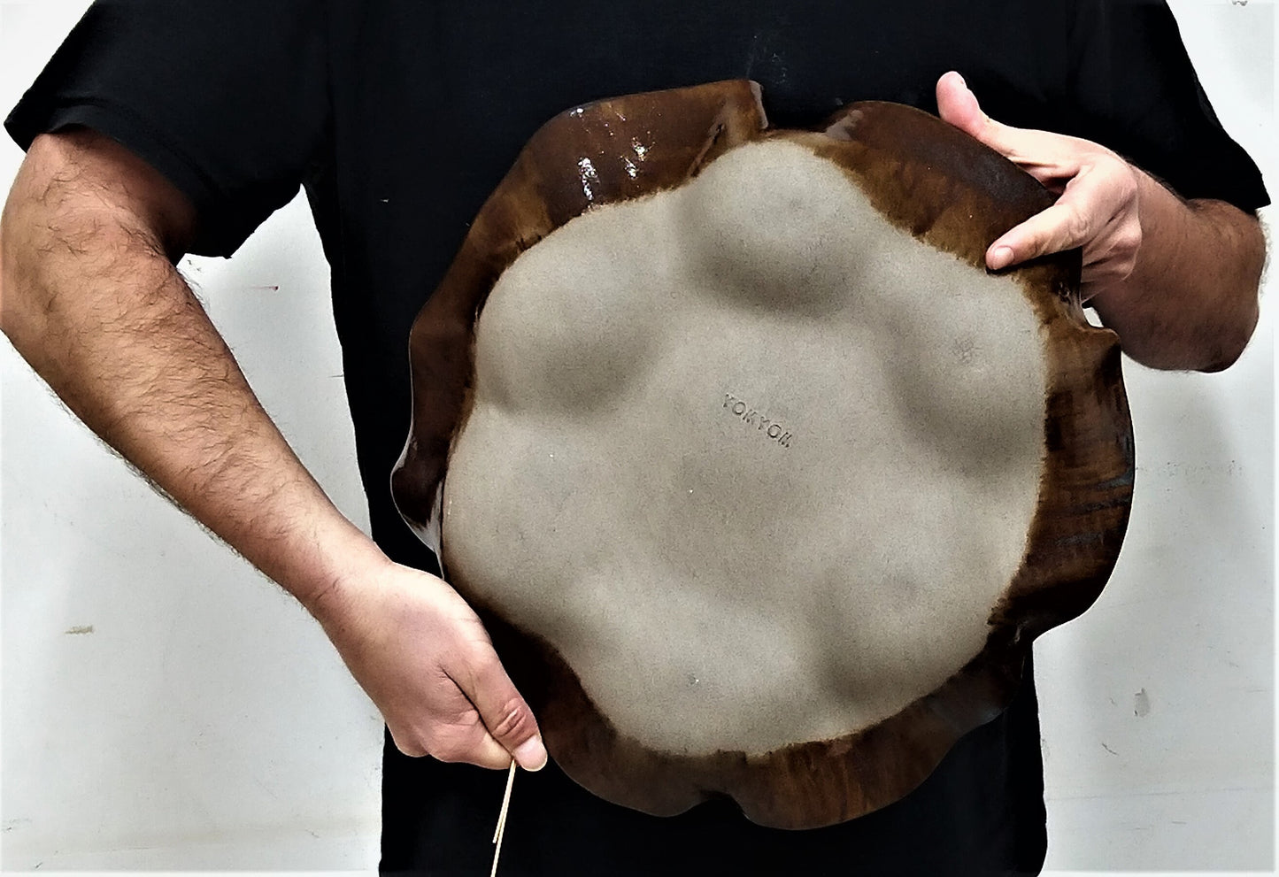 Back side of a gray clay Passover plate