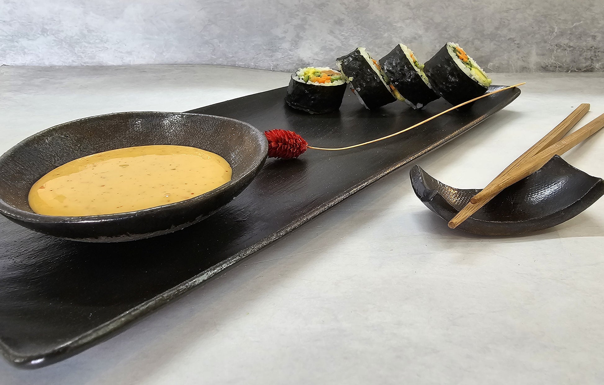 Sushi plate styled with decorative red flower
