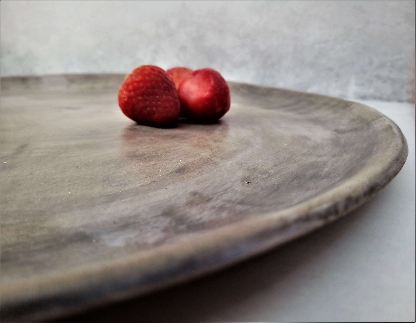 Dark gray runded ceramic handmade tray