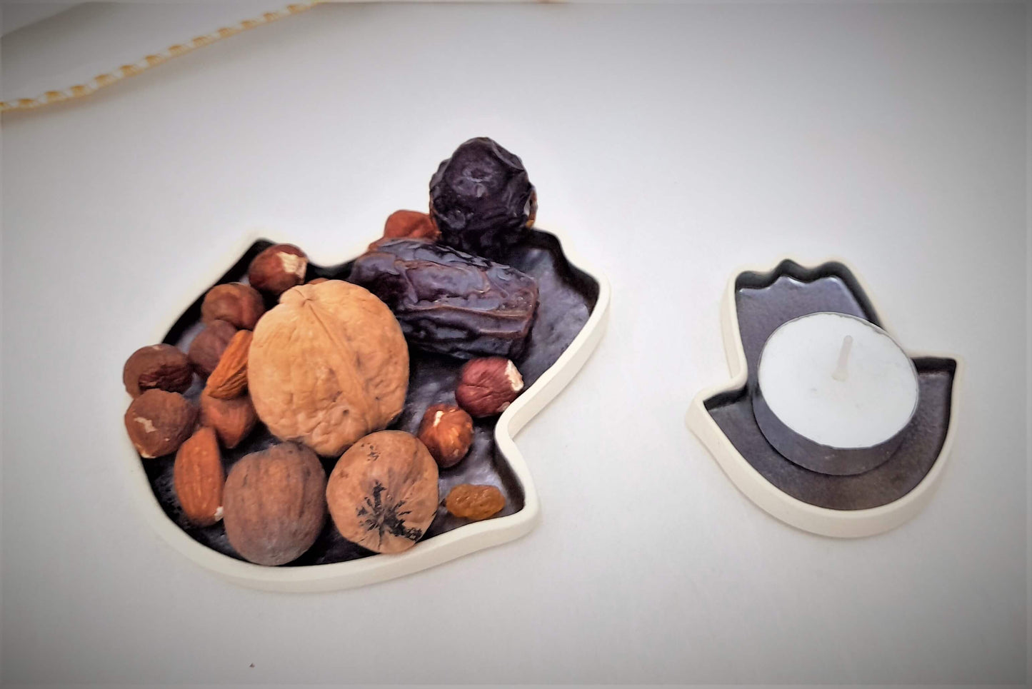 A large and a small hamsa plate