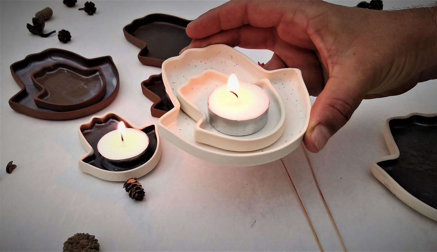 A white plate in the shape of a hamsa