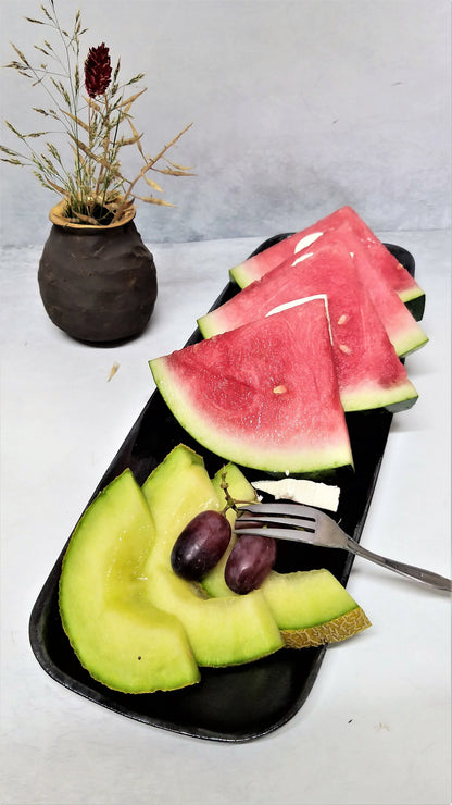 Watermelon on a black ceramic tray