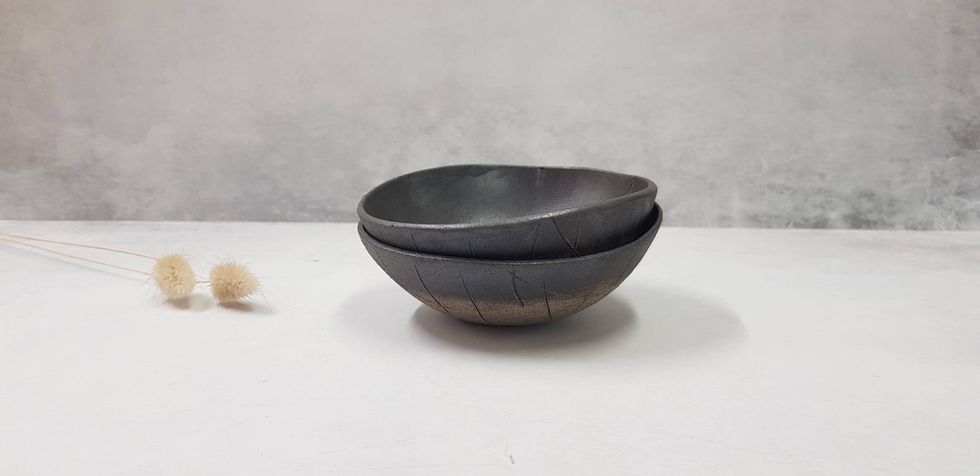 Two small black ceramic bowls