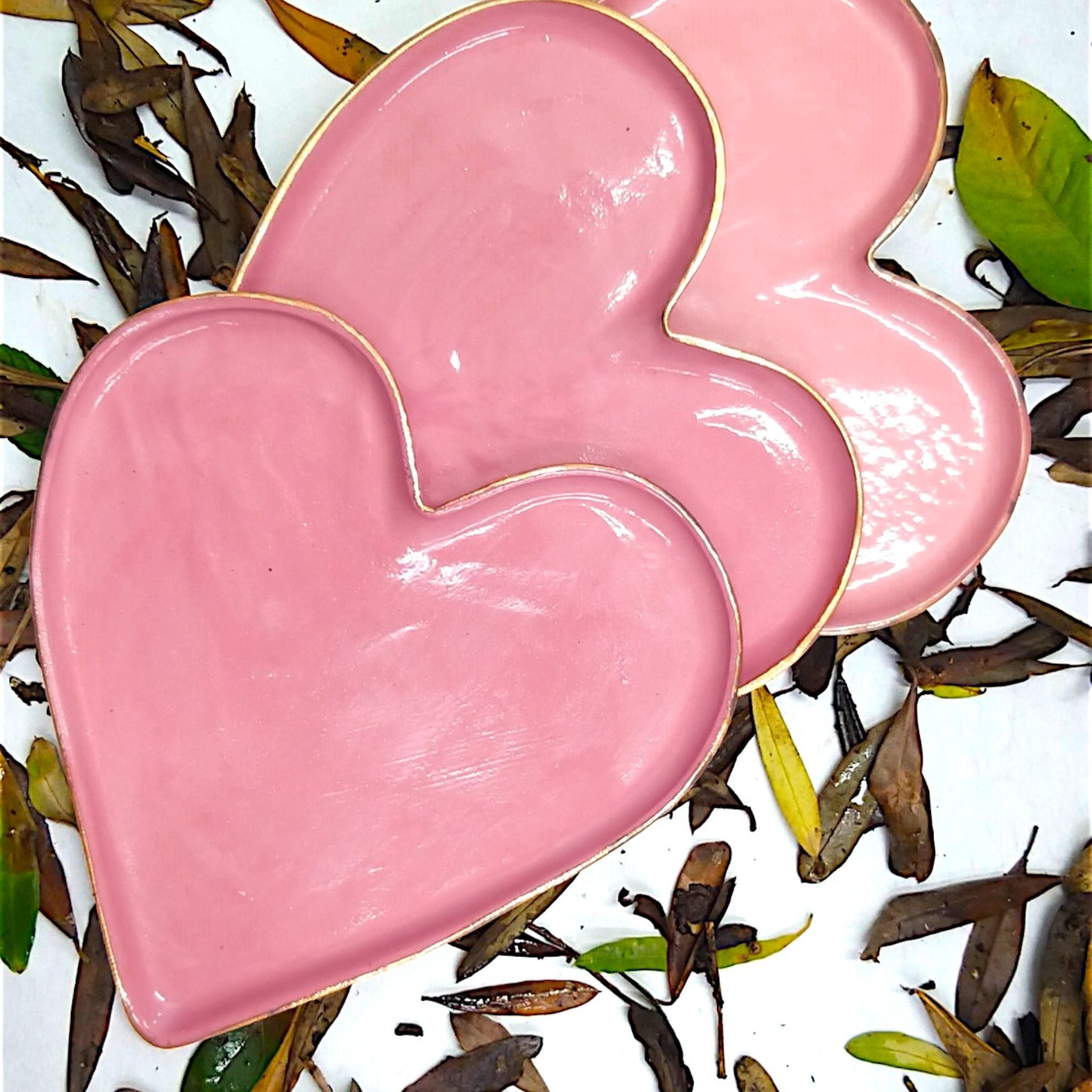 Three pink gold ceramic heart shapte plates