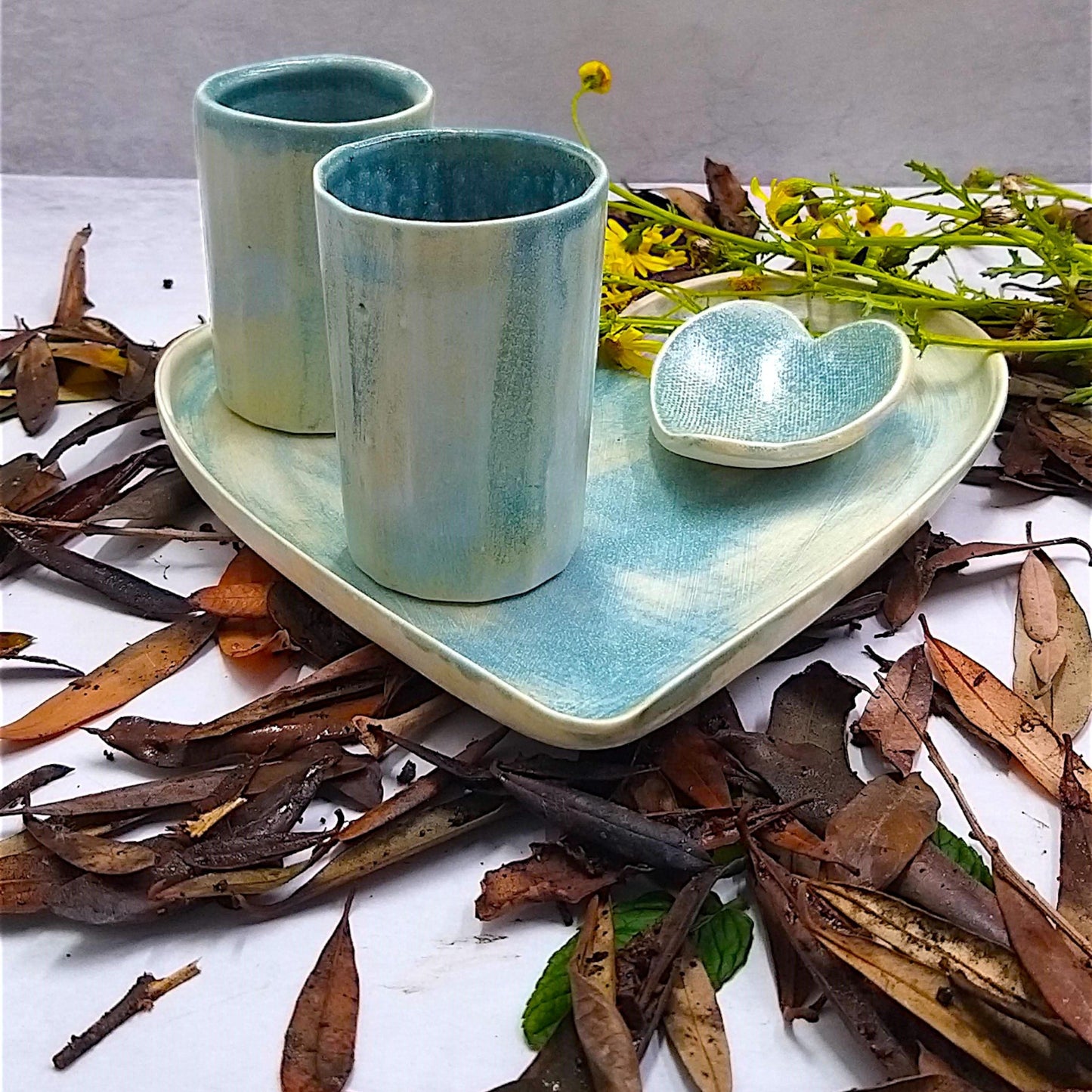 Two ceramic cups on heart plate