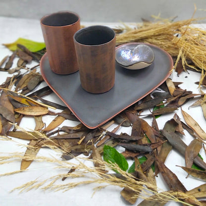Handmade chocolate brown ceramic dinnerware set with heart plate, glasses and bowl.