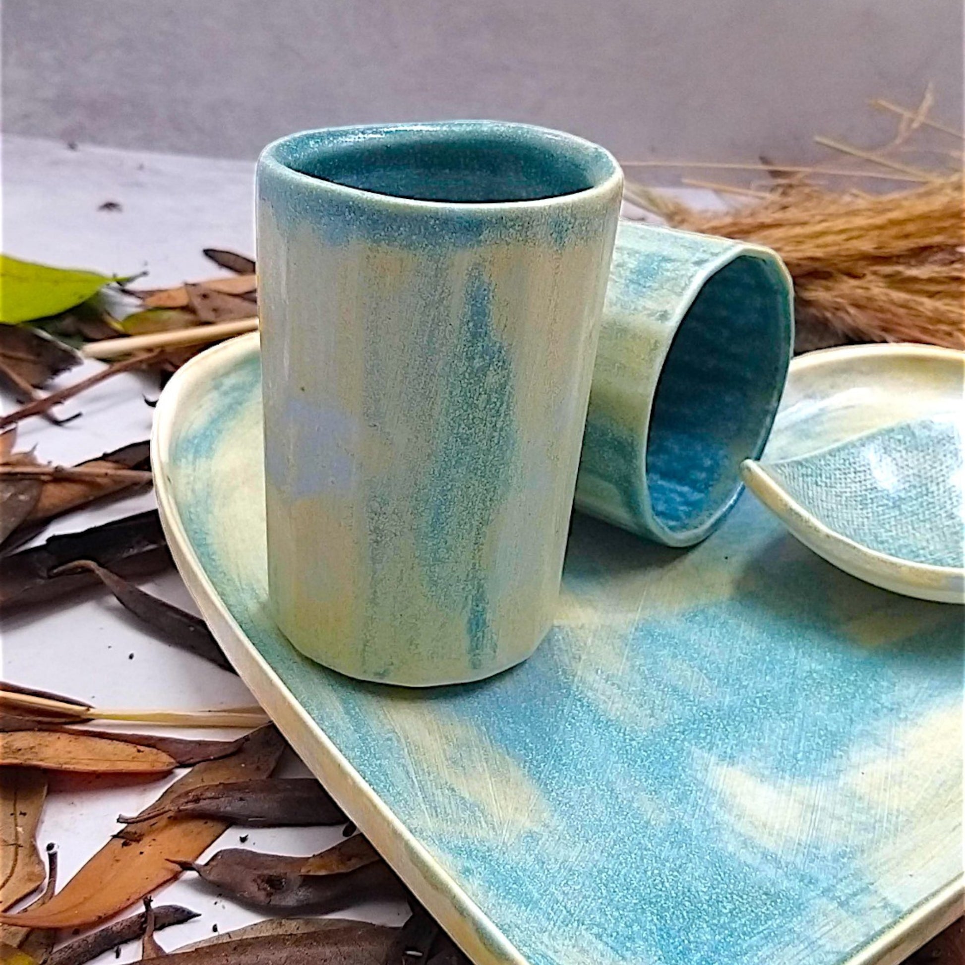 Bluish yellow handcrafted ceramic heart-themed plate, cups and bowl