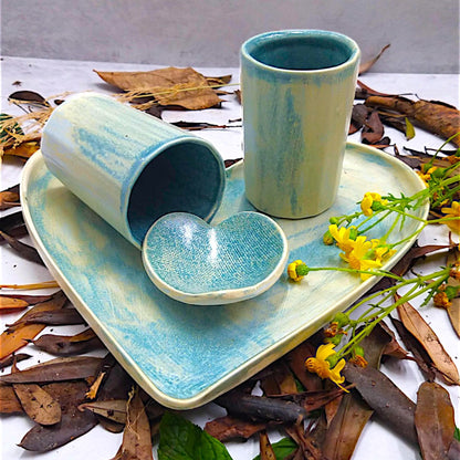 Bluish yellow ceramic heart-shaped platter, cylinder glasses and bowl