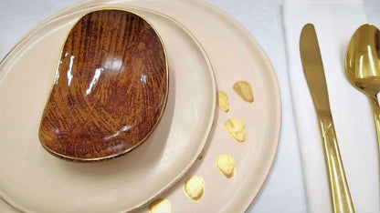 Set of three ceramic plates with 24k gold details on beige background