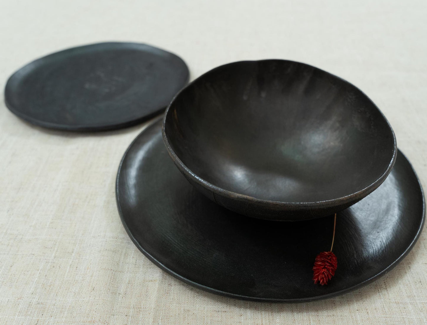 Layered black plates with wide bowl