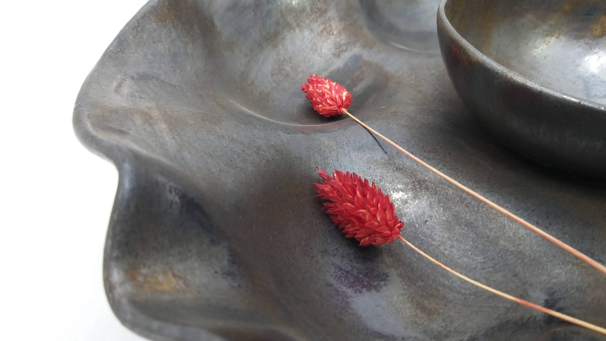 Close-up of ceramic serving bowl and textured dish
