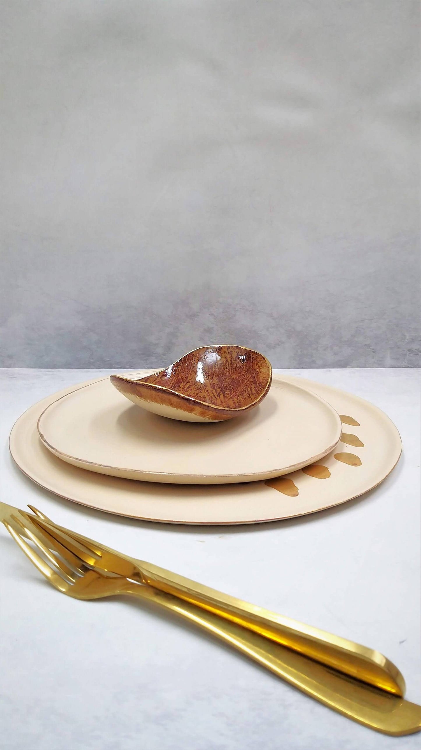 Unique handmade ceramic plates stacked, showing texture and detail