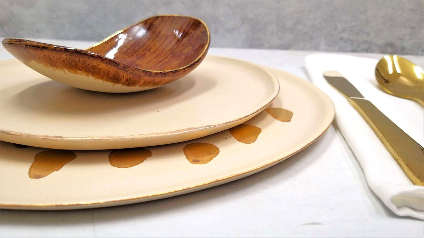 Close-up of 24k gold rim on handmade ceramic appetizer plate