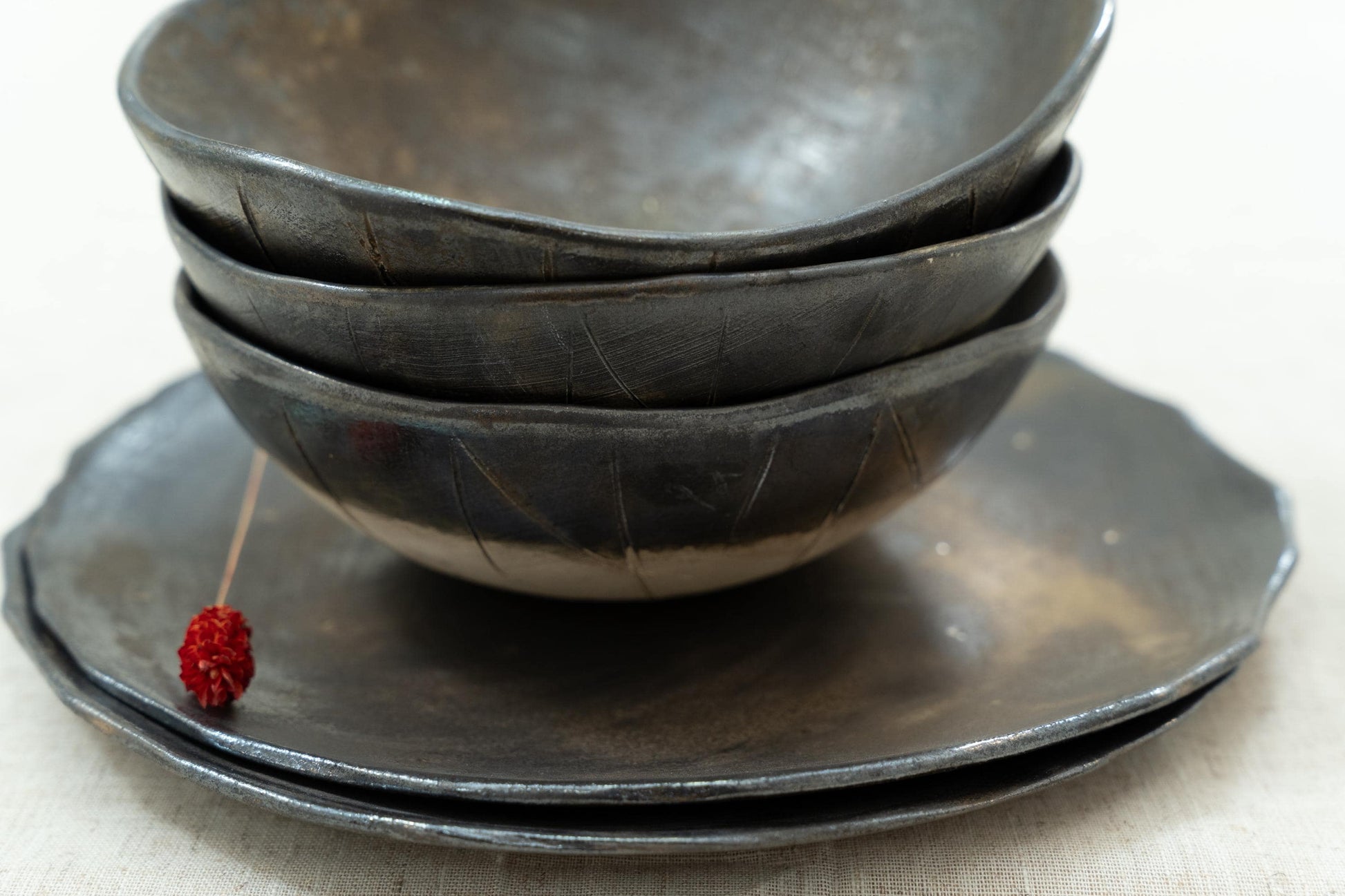 Close-up of bowls on plates with shiny glaze highlights