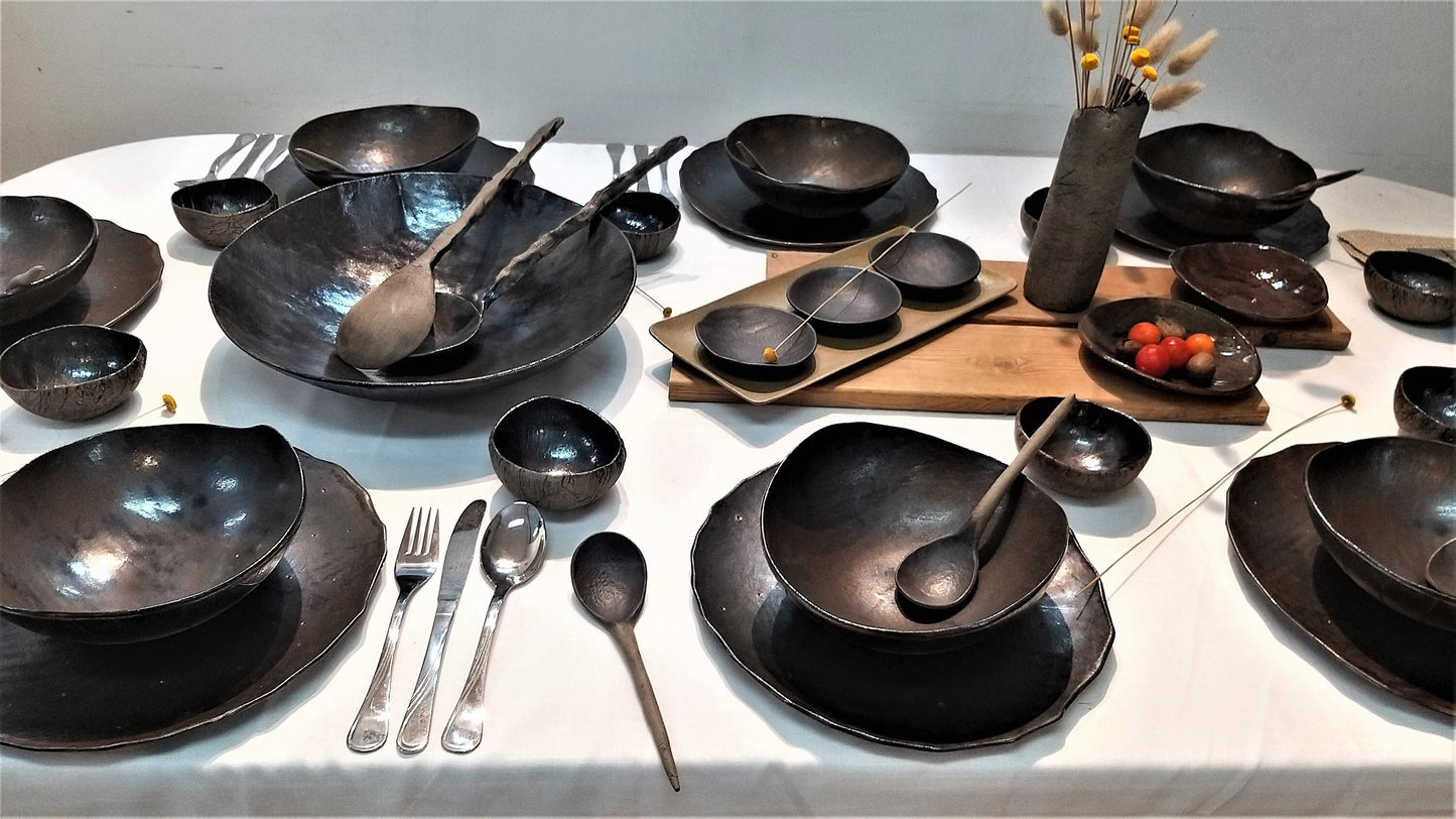 Large black ceramic dish set on a table