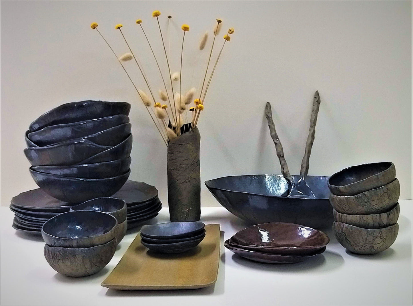 Ceramic dishes arranged in piles on a table