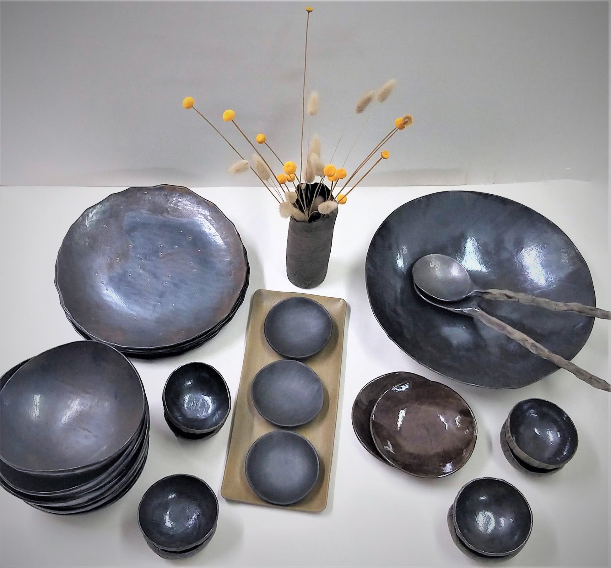 Display of black ceramic tableware placed on a table