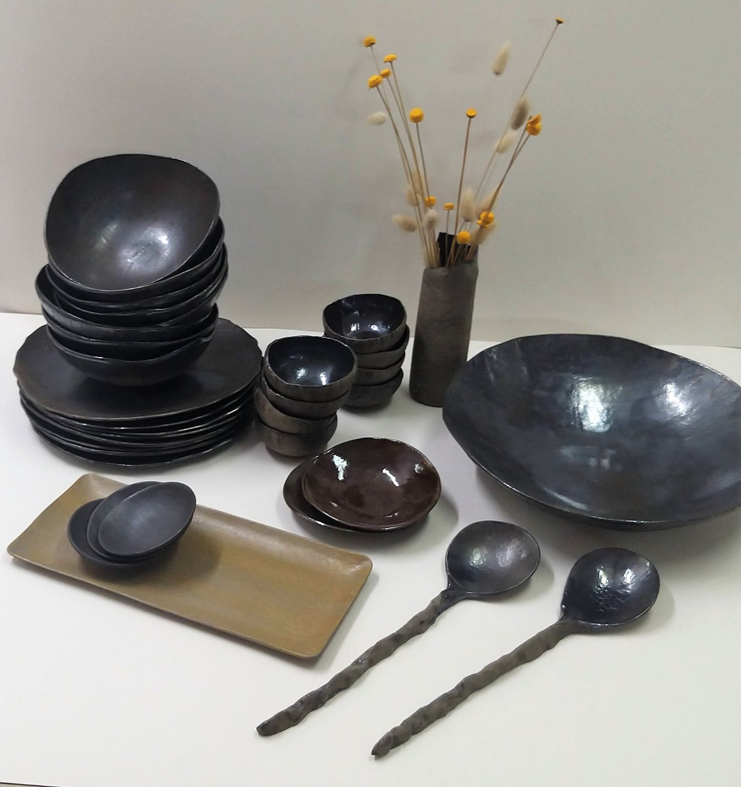 Stacks of black ceramic tableware