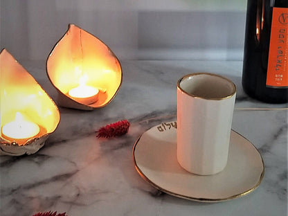 White ceramic kiddush cup and candlesticks