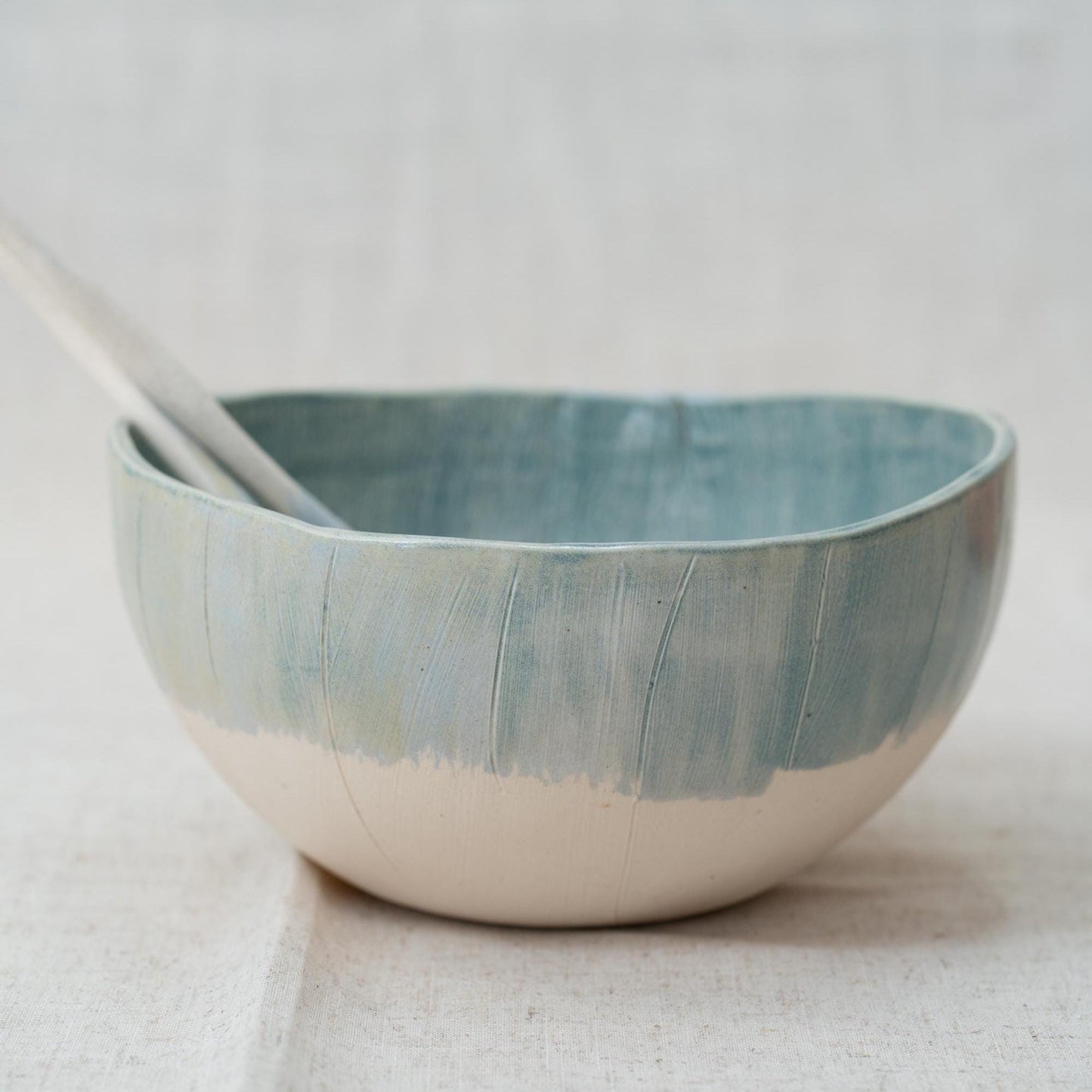 Ceramic bowl with a textured blue and white design on a light background